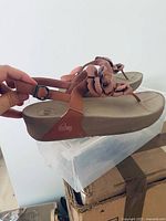 Side view of FitFlop pink flower sandals showing design and condition