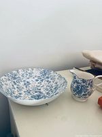 Serving bowl and creamer showing blue floral pattern