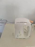 Left side profile showing mixer body and both stainless beaters attached