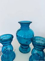 Front view of three blue glass pieces