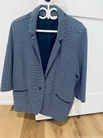 Navy-white striped blazer hanging