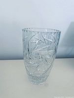 Full view of clear deep cut crystal vase standing upright