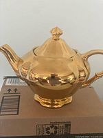Full view of gold Royal Winton teapot with lid on box