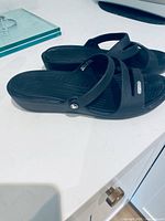 Side profile of pair showing straps, wedge heel and overall condition