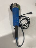 Full view of blue Mastercraft angle grinder with cord