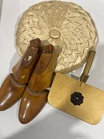 All three items grouped: wooden shoe stretchers, metal silent butler, cream round pillow