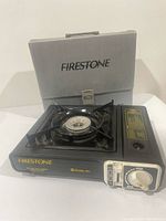 Stove on display with carrying case behind