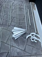All wire shelves, brackets, rods, rails and hardware laid out