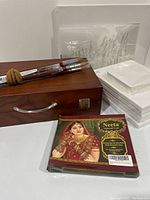 Overview of wooden box, brushes, canvases, henna package