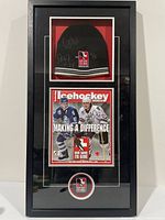 Full view of framed display showing hat and magazine