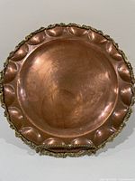 Front view of entire copper plate showing scalloped gold-tone rim