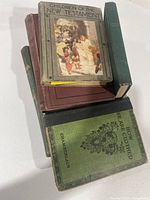 Stack of six antique books showing covers and colors