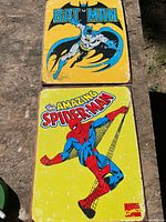 Both tin signs laid out showing full graphics