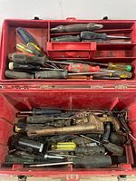 Open toolbox showing upper tray filled with screwdrivers