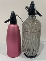 Front view of both soda siphons side by side