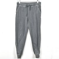 Front view of green velour jogger pants hanging