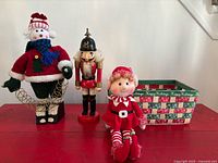 Group view of snowman, nutcracker, elf, and basket