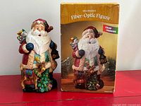 Front view of Santa figure beside retail box