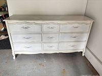 Full view of 9-drawer French Provincial dresser showing off-white color, curved apron, cabriole legs