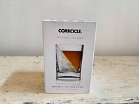 Front of sealed box showing Corkcicle Whiskey Wedge glass with diagonal ice