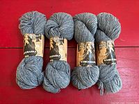 Four blue skeins with labels front view