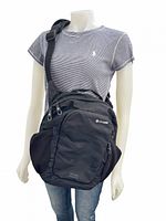 Front view of black Pacsafe sling bag on mannequin showing size and strap