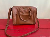 Front view showing colour, shape, front pocket and hardware