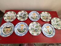 Nine plates displayed on red surface