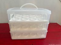 Front view of assembled three-tier Snapware cupcake carrier showing clear sides and white inserts