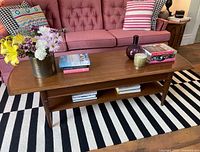 Full view of walnut coffee table styled with décor items