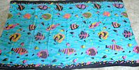 Full view of sarong showing entire tropical fish design and border