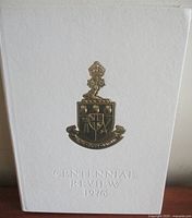 Front cover showing gilt crest and title Centennial Review 1976