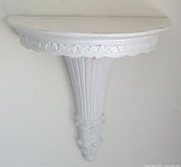 Full view of white embossed wall shelf on wall