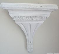 Front view of entire wall shelf showing embossed and fluted details
