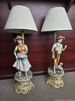 Front view of both porcelain figure lamps with shades