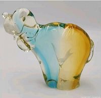 Full view of glass hound dog figurine showing color gradient and size