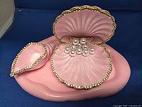 Full view of large scallop shell box on base with small shell dish