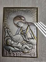 Close view of sterling silver relief showing Madonna and Child