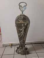 Screen folded closed showing female figure relief and glass handle