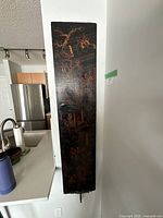 Full front view of tall black lacquered panel