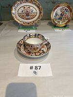 Saucer shown with matching teacup (teacup separate lot) on display table