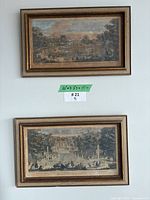 Two framed engravings hung on wall