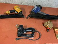 Two framing nailers, electric stapler/nailer visible