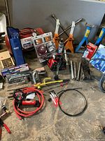 Overall view with battery charger, booster cables, jack stands, packaged lights, trim tool set, torque wrench sleeve, hitch bar, extension pipes