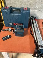 Full set showing Bosch case, laser level, receiver, bracket and folded tripod