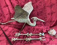 Full lot view: heron figure, directional arms, rod, globe