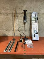 All items laid out including metal detector, magnetic tools, holder strips, mirror wand