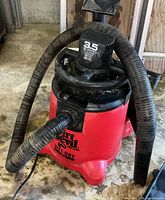 Vacuum showing hose attached and motor housing with 3.5 HP label