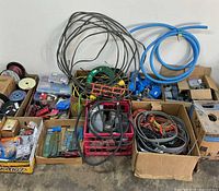 Overall view of boxes with wire, conduit, cables, hardware