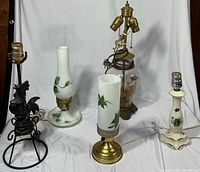 All five lamps grouped together showing styles and materials